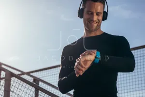 Athlete using smartwatch to monitor his progress